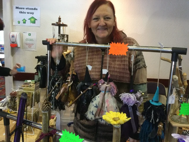 An exhibitor displaying handmade jewellery