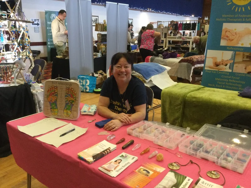 A wellbeing exhibitor at a pink-covered stand